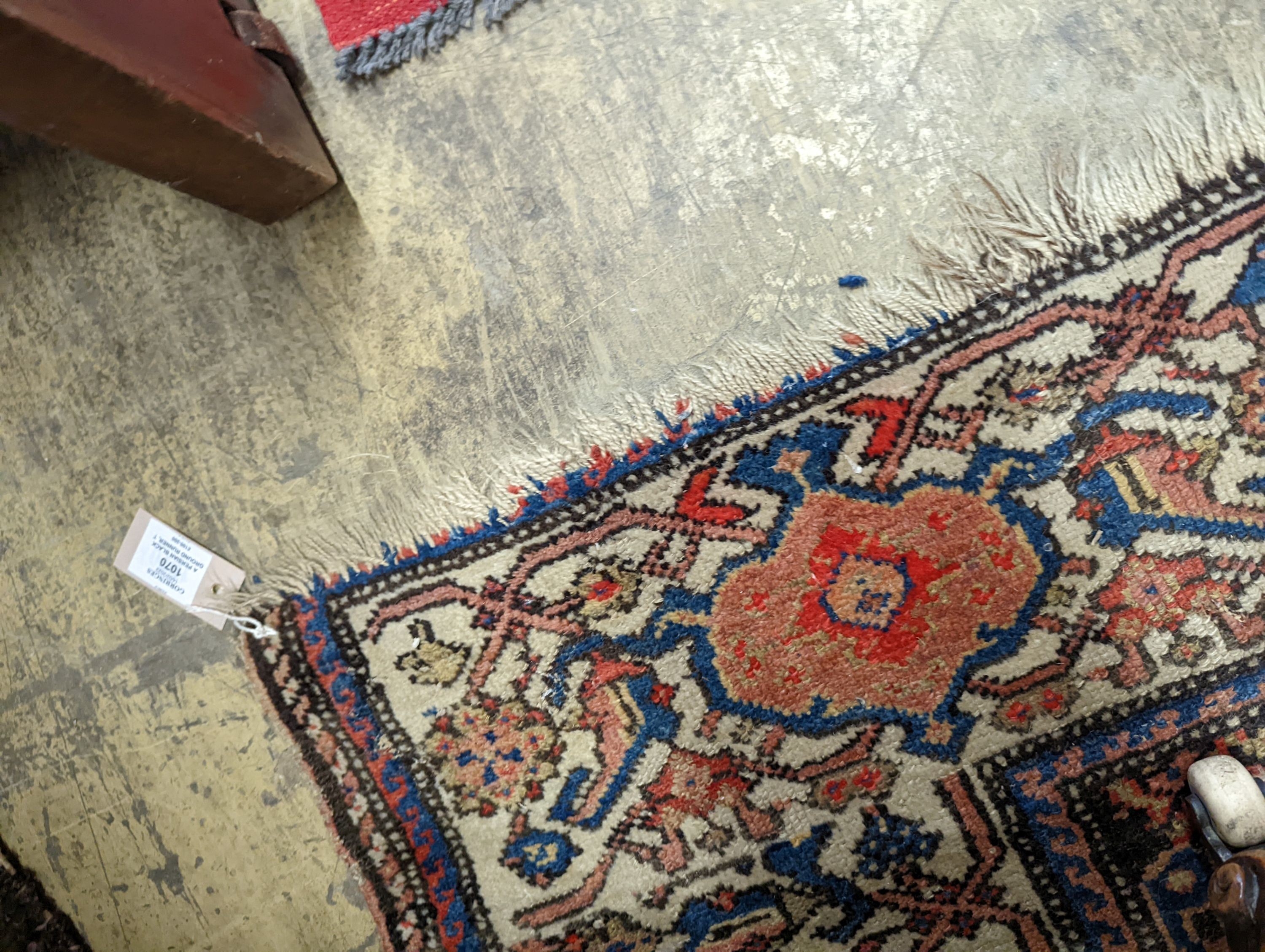 A Persian black ground runner, the central field including boteh motifs, 280 x 106cm, worn